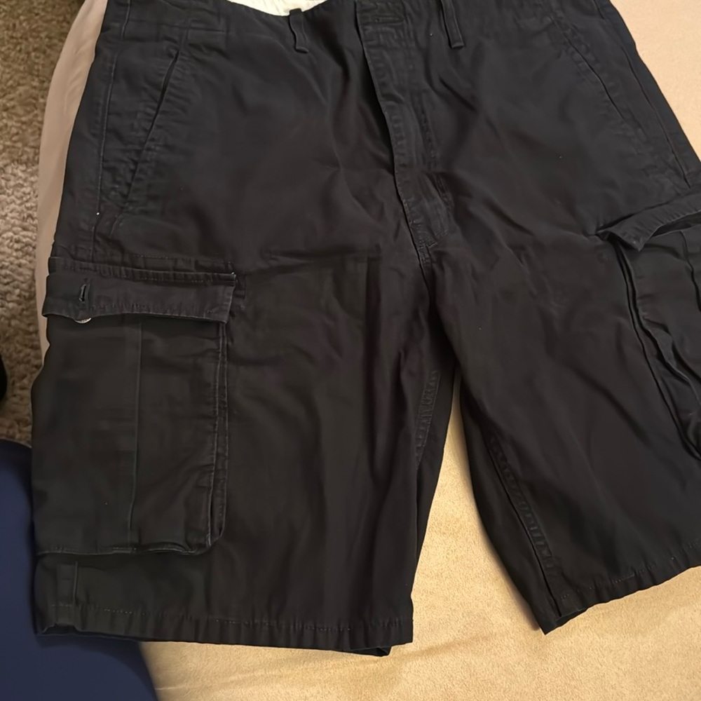 Man, black Levi's, 38 waist cargo shorts.